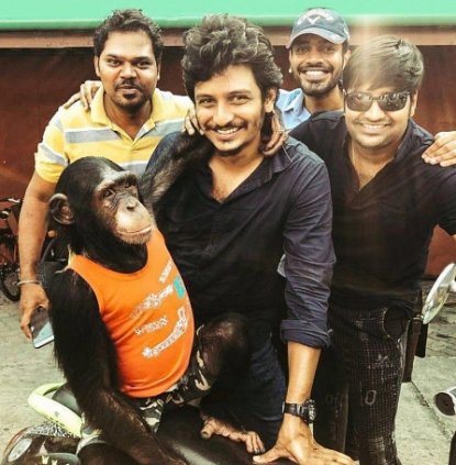 Jiiva with a chimpanzee in Thailand for a shoot